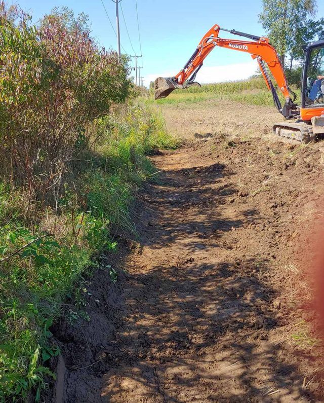 orange excavator digging up dirt