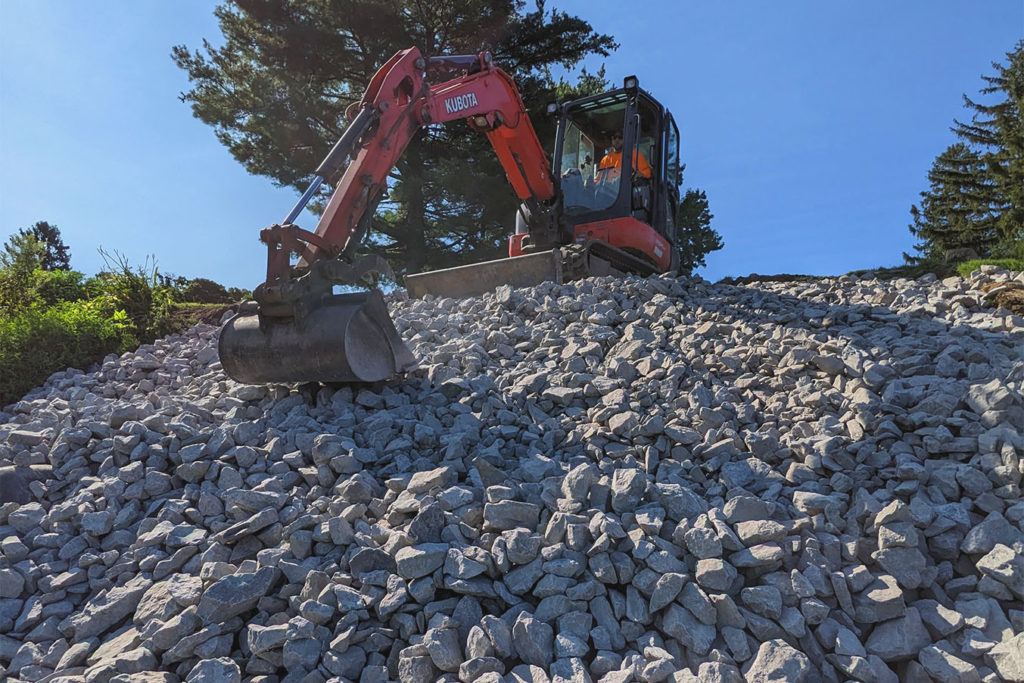 a JCB scraping up rocks