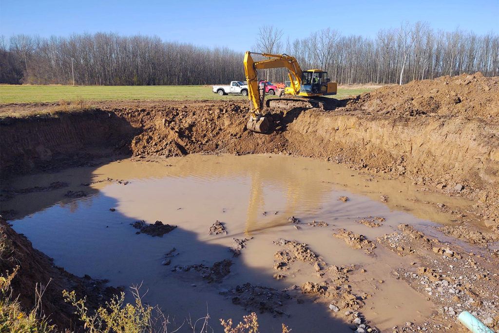 a JCB digging a hole in the ground