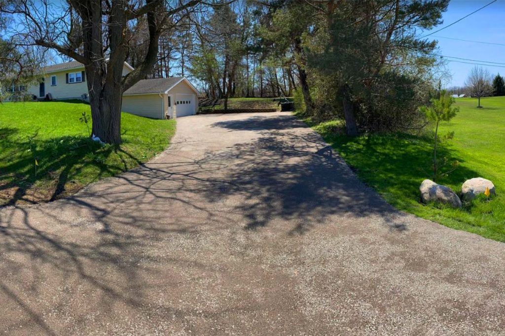 a driveway leading up to a country house