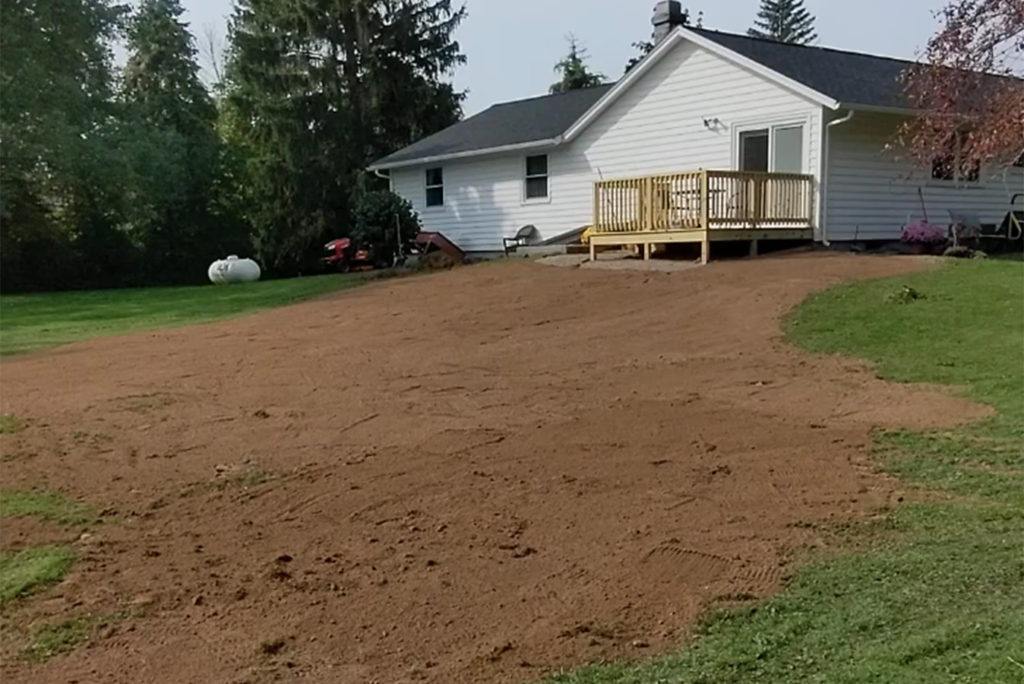 a house with sand spread out over the lawn
