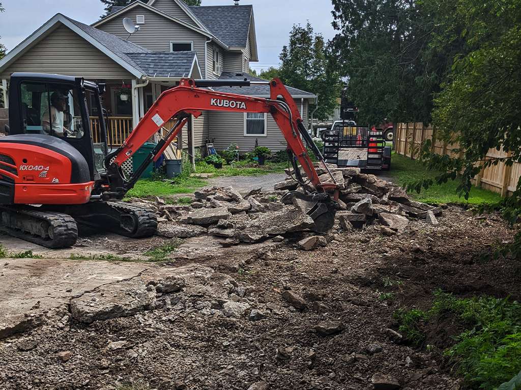 heavy machinery breaking up a section of concrete