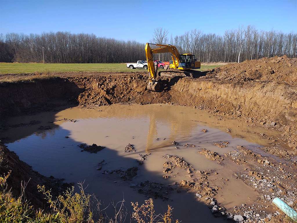 a digger working on excavating a pond