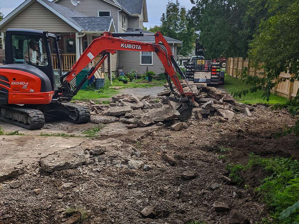 heavy machinery breaking up a section of concrete