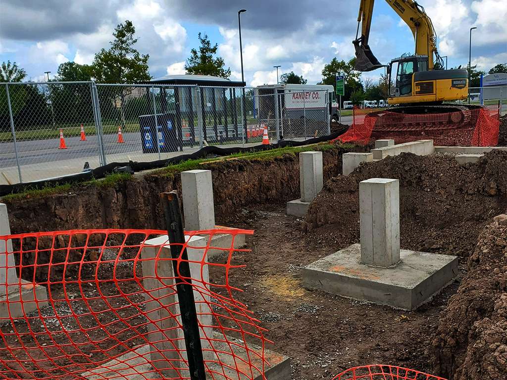 a digger working on the foundation of a build site