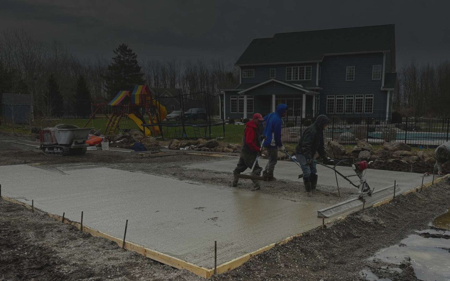 a group of laying down a concrete slab