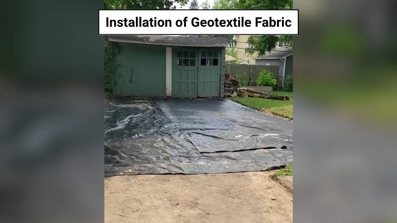 Fabric was installed in the grassy area near the garage