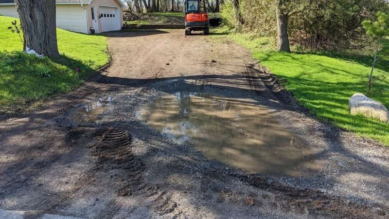 The condition of the driveway with a large pothole