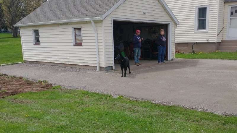 The repaired driveway (view showing the new gravel surface at the side of the garage)